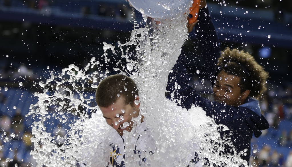 Tampa Bay Rays starting pitcher Chris Archer dumps a bucket of ice water on Brad Miller after the Rays defeated the Chicago White Sox 7-2 during a baseball game Saturday, April 16, 2016, in St. Petersburg, Fla. (AP Photo/Chris O'Meara)