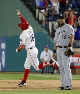 Texas Rangers' Ryan Rua celebrates his three-run home run as he rounds first behind Chicago White Sox's Jose Abreu (79) during the eighth inning of a baseball game, Tuesday, May 10, 2016, in Arlington, Texas. The Rangers won 13-11. (AP Photo/Tony Gutierrez)